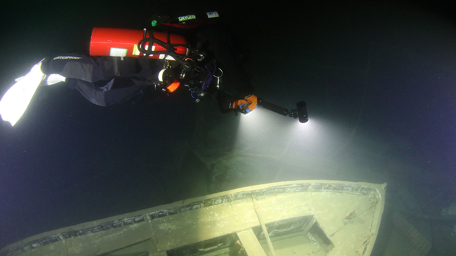Diver light illuminating shipwreck detail