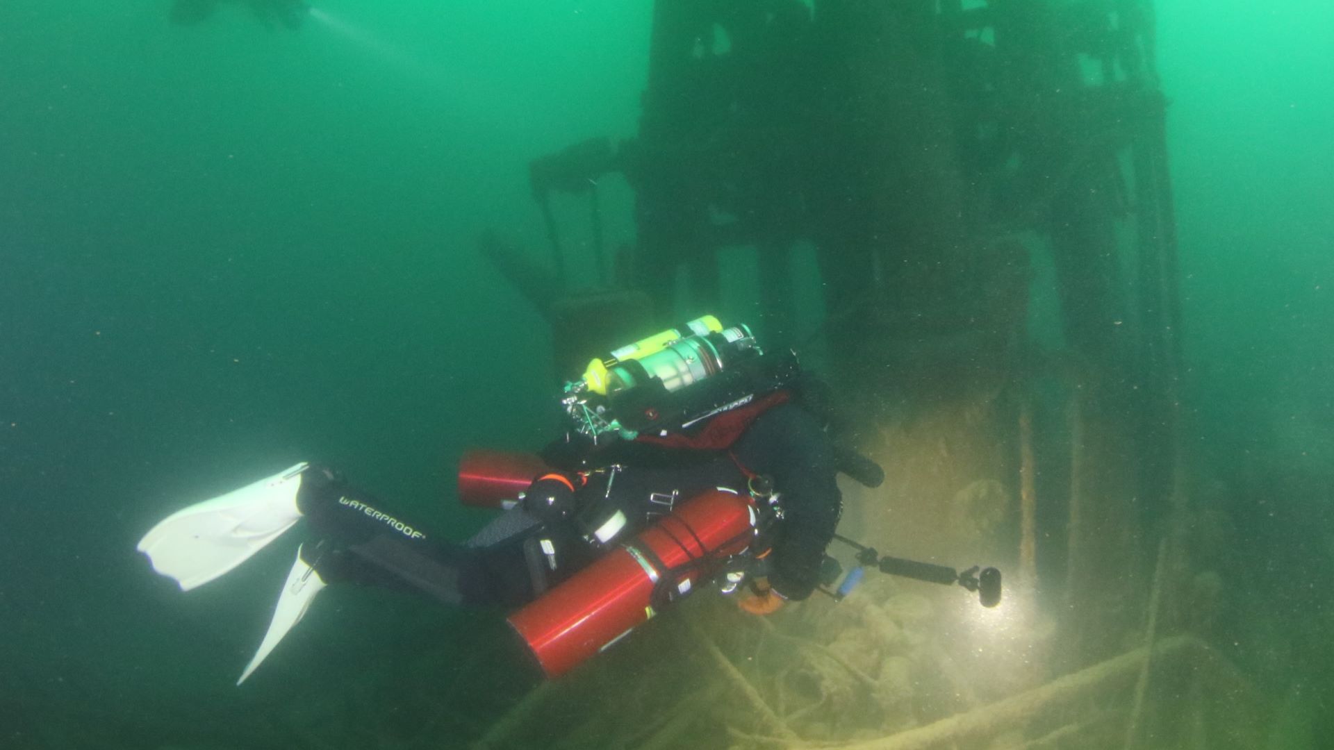 Confident diver in dark blue-green water