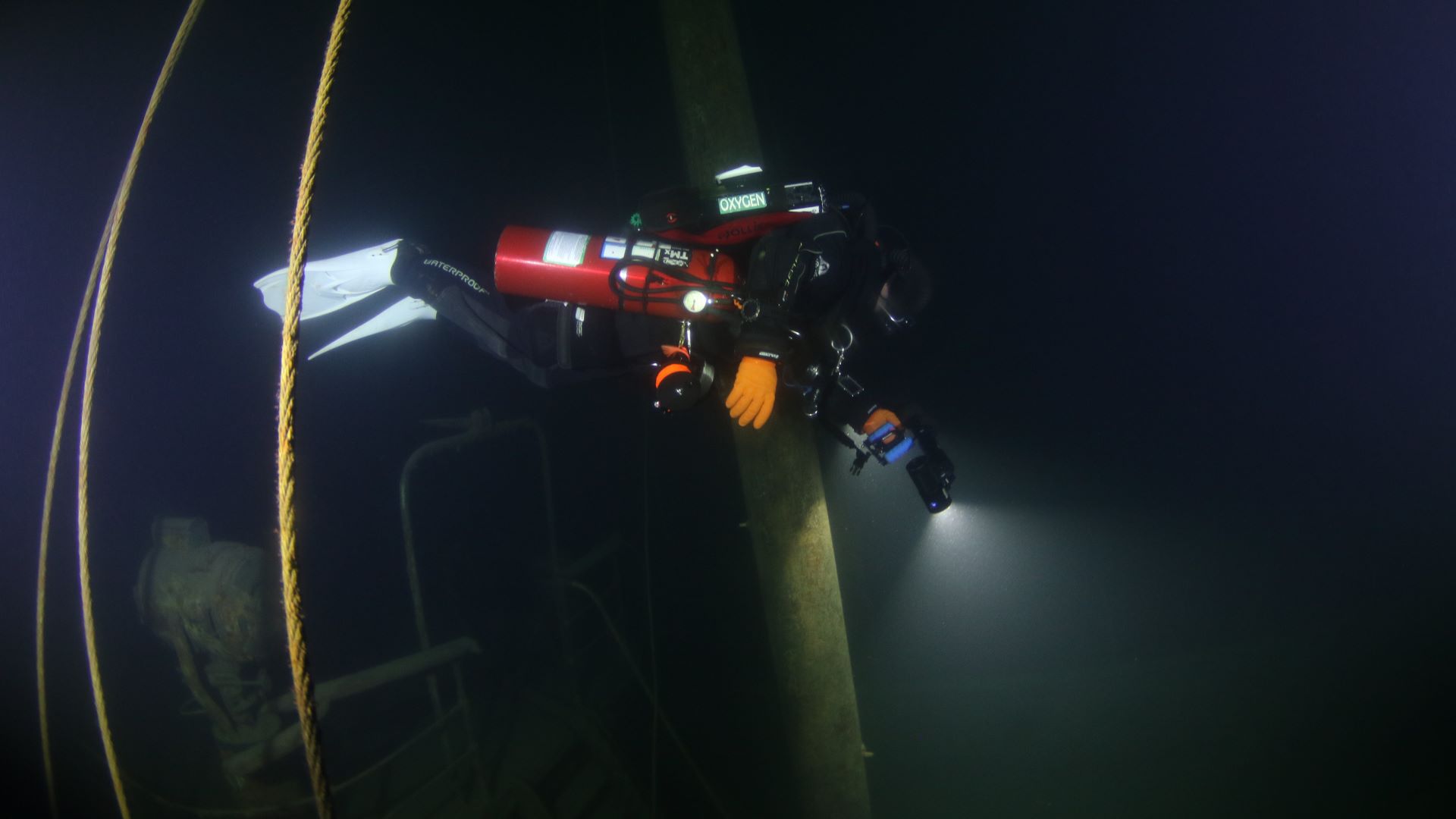 Diver stepping toward Great Lakes wreck diving
